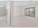 Primary bedroom with an attached bathroom, sliding glass doors and a private balcony at 5201 Lake Hinden Cv, St Cloud, FL 34771