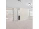 View of a hallway with an adjacent living area and an opened bathroom at 5201 Lake Hinden Cv, St Cloud, FL 34771