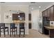 Modern kitchen with dark wood cabinetry, granite countertops, stainless steel appliances, and bar seating at 5201 Lake Hinden Cv, St Cloud, FL 34771
