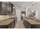 Spacious kitchen with dark wood cabinets, stainless steel appliances, and granite countertops at 5201 Lake Hinden Cv, St Cloud, FL 34771