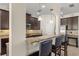 Gourmet kitchen featuring dark cabinetry, bar seating, granite countertops, and stainless-steel appliances at 5201 Lake Hinden Cv, St Cloud, FL 34771