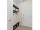 Mud room with bench, storage, and access to exterior at 5201 Lake Hinden Cv, St Cloud, FL 34771