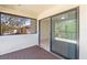 This screened patio has a sliding door that opens up to the exterior and overlooks a lush yard at 5201 Lake Hinden Cv, St Cloud, FL 34771
