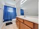 Bathroom featuring vanity with sink, toilet and blue shower curtain at 550 Michigan Estates Cir, St Cloud, FL 34769