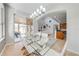 Modern dining room with a glass table, stylish chairs, and open layout leading to the patio at 550 Michigan Estates Cir, St Cloud, FL 34769