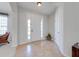 Bright foyer with tiled floor, white front door and transom windows at 550 Michigan Estates Cir, St Cloud, FL 34769