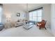 Cozy living room with elegant chandelier, comfortable seating, and bright natural light at 550 Michigan Estates Cir, St Cloud, FL 34769