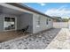 Covered back patio with tile flooring and a paved stone area with a chair at 6592 Taxiway Cir, Orlando, FL 32822