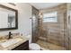Beautiful bathroom with granite countertop, undermount sink, and a glass-enclosed tiled shower at 6592 Taxiway Cir, Orlando, FL 32822