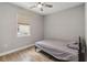 Comfortable bedroom with wood-look tile flooring, a ceiling fan, and a large window at 6592 Taxiway Cir, Orlando, FL 32822