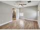 Bedroom featuring tile flooring, neutral walls, a ceiling fan, and an ensuite bathroom at 6592 Taxiway Cir, Orlando, FL 32822