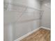 Walk-in closet with wire shelving and wood-look tile flooring at 6592 Taxiway Cir, Orlando, FL 32822
