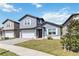 Lovely two-story home features a garage, manicured lawn, and welcoming front entrance at 6592 Taxiway Cir, Orlando, FL 32822