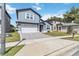 Exterior view of a two-story home with a well-maintained lawn and paved driveway at 6592 Taxiway Cir, Orlando, FL 32822