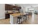 Open kitchen featuring dark cabinetry, granite countertops, stainless steel appliances, and a breakfast bar at 6592 Taxiway Cir, Orlando, FL 32822