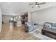 Bright, open-concept living space featuring tile floors, stylish furniture, and a kitchen island with bar stools at 6592 Taxiway Cir, Orlando, FL 32822