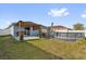 This backyard features a pergola-covered patio, above ground pool, and shed, offering a private outdoor space at 669 Persian Dr, Haines City, FL 33844