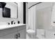 Modern bathroom featuring sleek black fixtures, a shower-tub combo, and elegant marble-look tile at 669 Persian Dr, Haines City, FL 33844