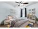 Bright bedroom featuring light blue walls, a ceiling fan, playful wall decor, and a comfortable bed at 669 Persian Dr, Haines City, FL 33844