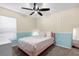 Cozy bedroom featuring a ceiling fan, complementary decorations, and a comfortable bed at 669 Persian Dr, Haines City, FL 33844