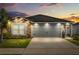 Charming home featuring a two-car garage, stone accents, solar panels and a well-manicured lawn at 669 Persian Dr, Haines City, FL 33844