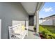 Inviting front porch with a comfortable bench, decorative pillows, and a view of the manicured lawn at 669 Persian Dr, Haines City, FL 33844