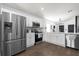 Modern kitchen with stainless steel appliances, white cabinets, and stylish fixtures, perfect for cooking at 669 Persian Dr, Haines City, FL 33844