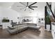 Open-concept living space featuring a gray sofa, modern decor, and flowing transition to the kitchen at 669 Persian Dr, Haines City, FL 33844
