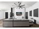 Contemporary living room with a stylish gray sectional sofa, dark accents, and modern decor at 669 Persian Dr, Haines City, FL 33844