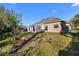 Spacious backyard with a brick-accented home and ample green space at 673 Leland Dr, Deltona, FL 32725