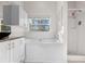 Bathroom features tub and a shower, white cabinets, and granite countertop at 673 Leland Dr, Deltona, FL 32725