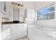 Bright bathroom with white cabinets, vessel sink, tub, and a window at 673 Leland Dr, Deltona, FL 32725