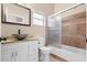 Bathroom featuring vanity with granite countertop, vessel sink, and tiled shower at 673 Leland Dr, Deltona, FL 32725