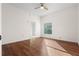 Bright bedroom features a ceiling fan, hardwood floors, and a window that provides natural light at 673 Leland Dr, Deltona, FL 32725