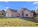 Brick home exterior showcasing the front lawn and attached two-car garage at 673 Leland Dr, Deltona, FL 32725