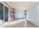 Enclosed patio with tiled floor, sliding glass doors, and custom shelving unit at 673 Leland Dr, Deltona, FL 32725