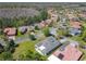 Community aerial view showcasing the house with the neighborhood, trees and landscaping and a nearby pond at 759 Villa Park Rd, Poinciana, FL 34759