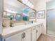 Bright bathroom with large mirror, double sinks, ample vanity storage and a walk-in shower at 759 Villa Park Rd, Poinciana, FL 34759
