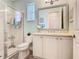 Bright bathroom features a glass enclosed shower and a vanity with a large framed mirror at 759 Villa Park Rd, Poinciana, FL 34759