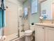 Bathroom featuring modern vanity, framed mirror, and glass-enclosed shower at 759 Villa Park Rd, Poinciana, FL 34759