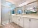Bright bathroom features a large mirror and a walk-in shower with glass door at 759 Villa Park Rd, Poinciana, FL 34759
