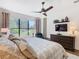 Comfortable bedroom features a large window with views of the backyard and wooded area at 759 Villa Park Rd, Poinciana, FL 34759