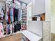 Walk-in closet with clothing racks, shelves, drawers, storage and a small bench at 759 Villa Park Rd, Poinciana, FL 34759