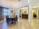Elegant dining room featuring a large table, chandelier, and open access to the living areas at 759 Villa Park Rd, Poinciana, FL 34759