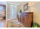 Inviting foyer with decorative mirror, stylish console table, and a view of the front door at 759 Villa Park Rd, Poinciana, FL 34759