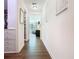 Hallway with wood floors and views of the living room and a closet at 759 Villa Park Rd, Poinciana, FL 34759