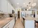 Beautiful kitchen features stainless steel appliances, mosaic backsplash, and walk-in pantry at 759 Villa Park Rd, Poinciana, FL 34759