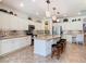 Bright kitchen with island and bar stools; stainless steel appliances, and mosaic backsplash at 759 Villa Park Rd, Poinciana, FL 34759
