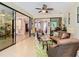 Bright living room with sliding glass doors that lead into the dining room and kitchen at 759 Villa Park Rd, Poinciana, FL 34759