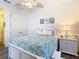 Bright main bedroom featuring white furniture, wood floors and soft linens at 759 Villa Park Rd, Poinciana, FL 34759